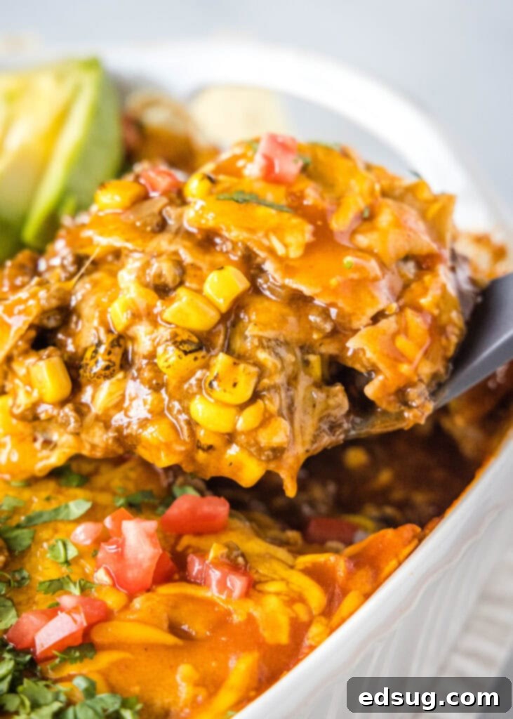 Cheesy Beef Enchilada Delight 5 scooping enchilada casserole out of the pan