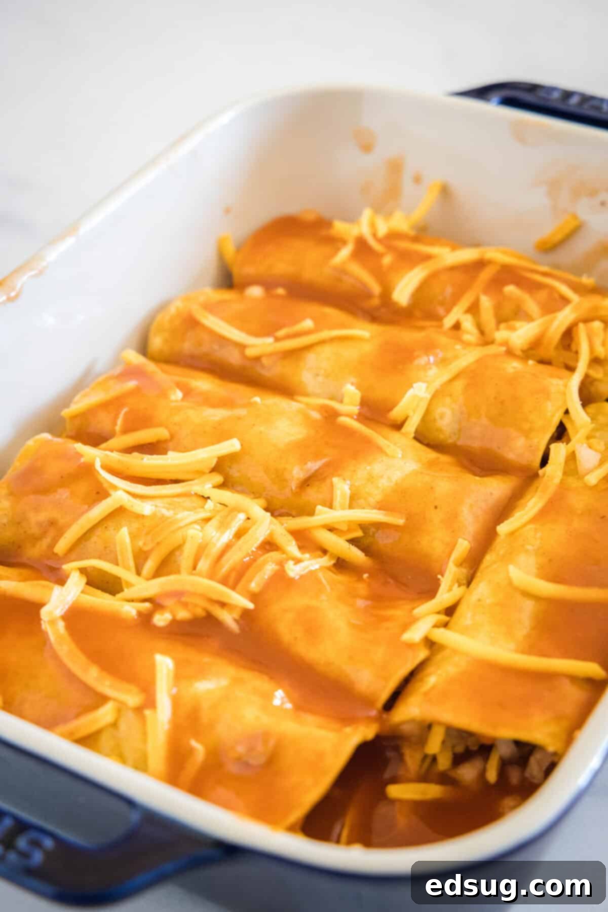 Savory Pork Enchiladas 7 enchiladas in pan ready to go in the oven