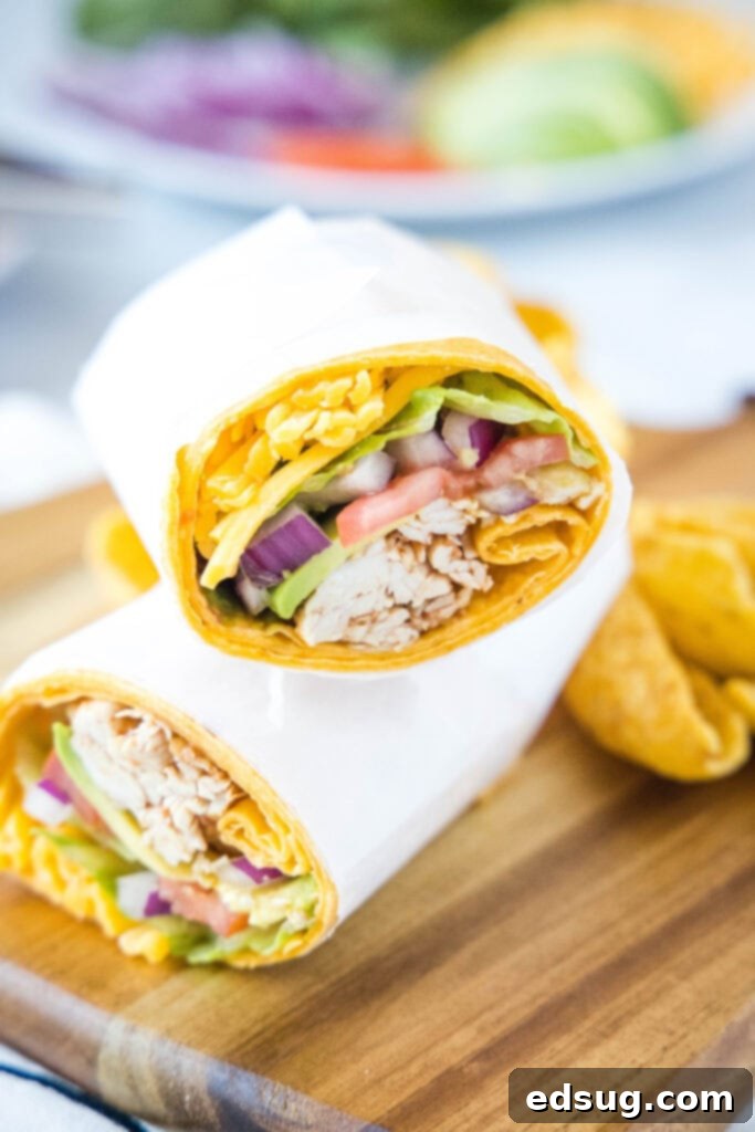 chicken wrap sliced in half on a cutting board