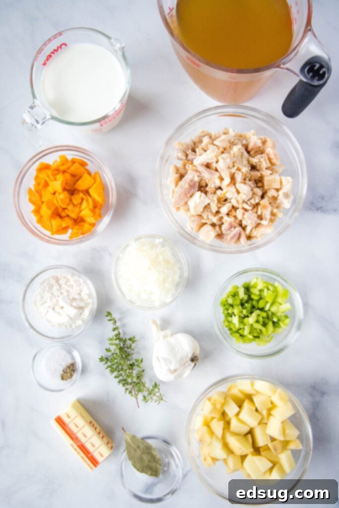Creamy Chicken Pot Pie Soup 3 Various fresh and pantry ingredients laid out on a kitchen counter, including butter, onions, carrots, celery, garlic, flour, chicken broth, potatoes, milk, peas, shredded chicken, and fresh thyme, prepared for making chicken pot pie soup.