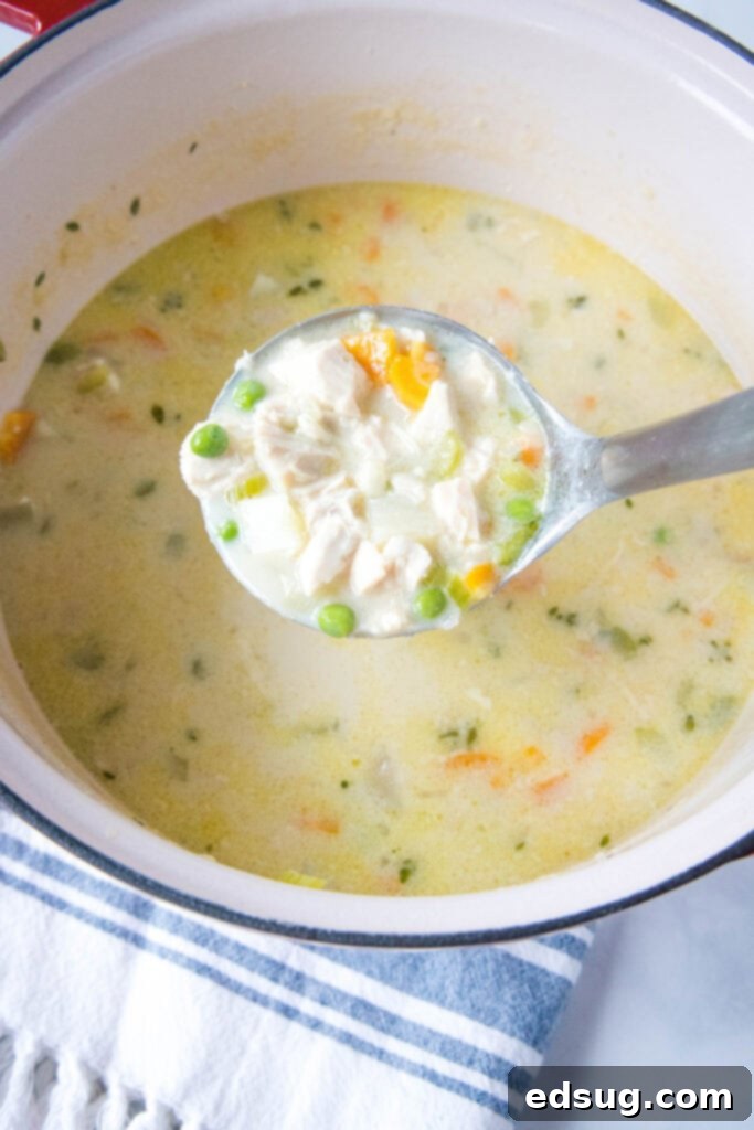 Creamy Chicken Pot Pie Soup 4 A large stock pot filled with creamy chicken pot pie soup, with a ladle resting inside, ready for serving.