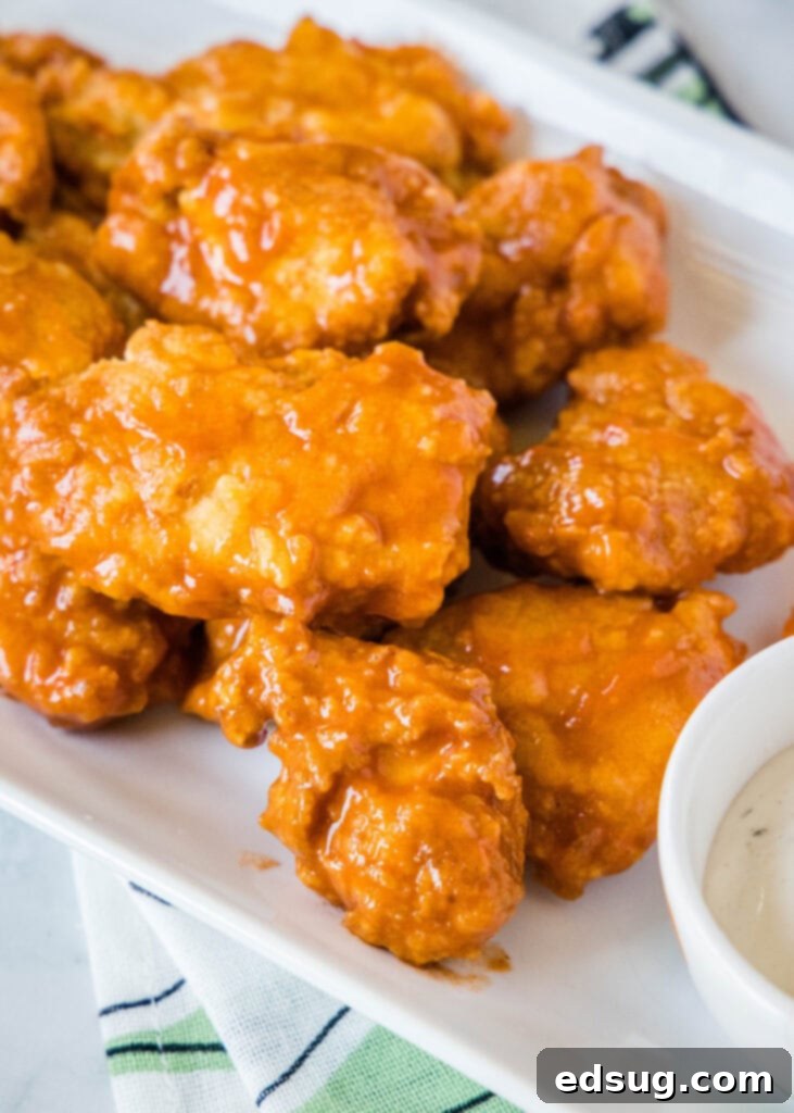 Crispy Chicken Poppers 2 boneless chicken wings on a white plate with ranch dressing