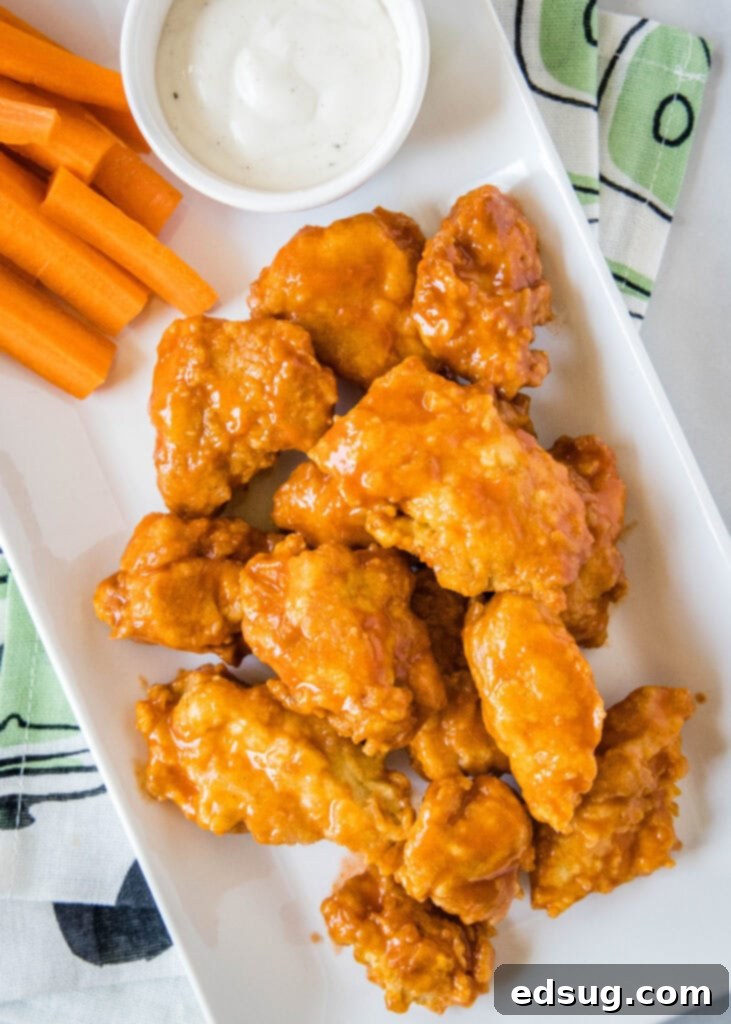 Crispy Chicken Poppers 5 buffalo chicken wings on a plate with carrots and ranch
