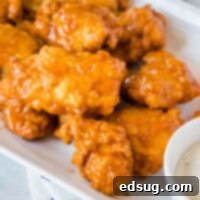Crispy Chicken Poppers 9 close up boneless chicken wings on a white plate with ranch