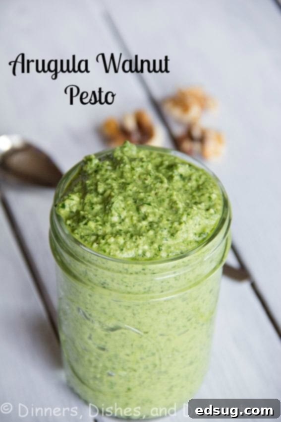 arugula walnut pesto in a jar, showcasing its vibrant green color