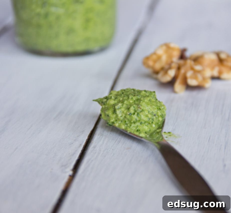 arugula walnut pesto in a jar, showcasing its vibrant green color for storage