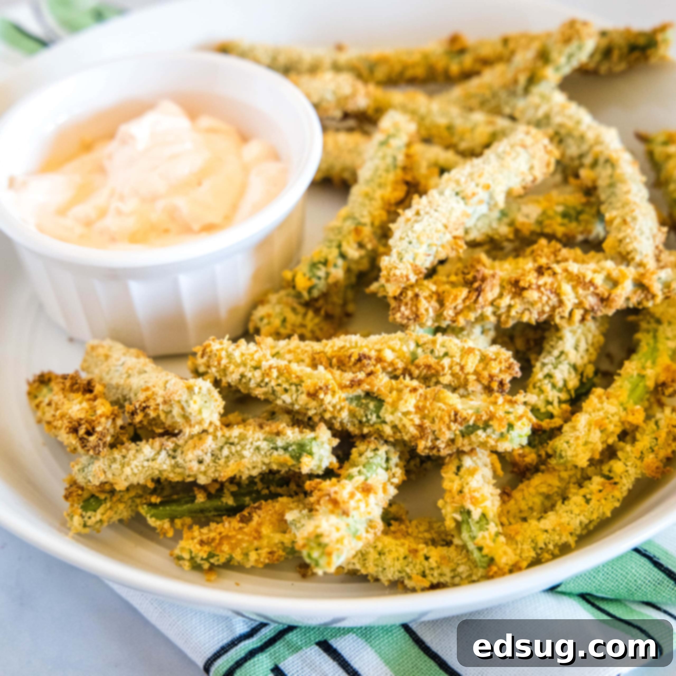 cropped in close up of air fryer green bean fries