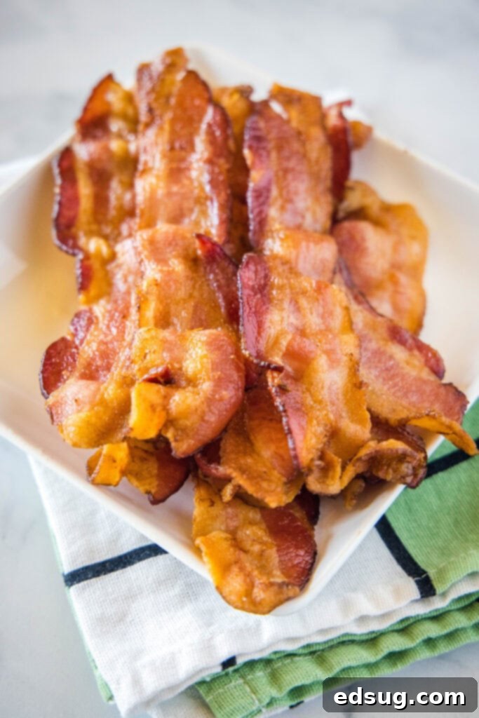 Perfect Air Fryer Bacon 2 strips of bacon on a white plate