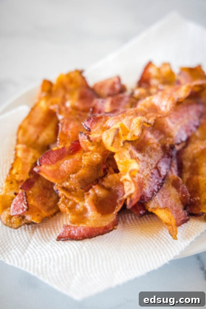 Perfect Air Fryer Bacon 4 bacon draining on a paper towel