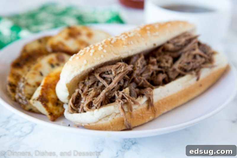 Slow Cooker French Dip - juicy tender beef cooked in a savory broth and served on a French roll. Au jus is great for dipping and make this crock pot recipe a staple in any house! French Dip recipe sandwich with cheese and au jus