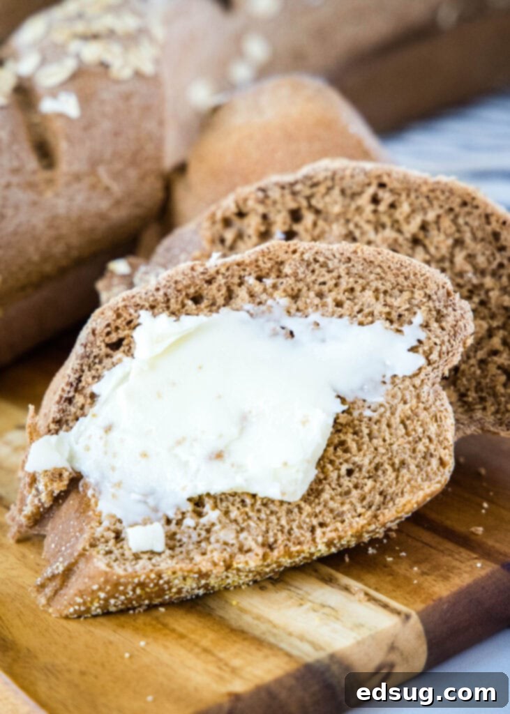 butter on a slice of brown bread on a cutting board