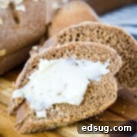slice of bread with butter on a cutting board