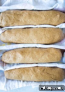 shaped brown bread down on baking sheet
