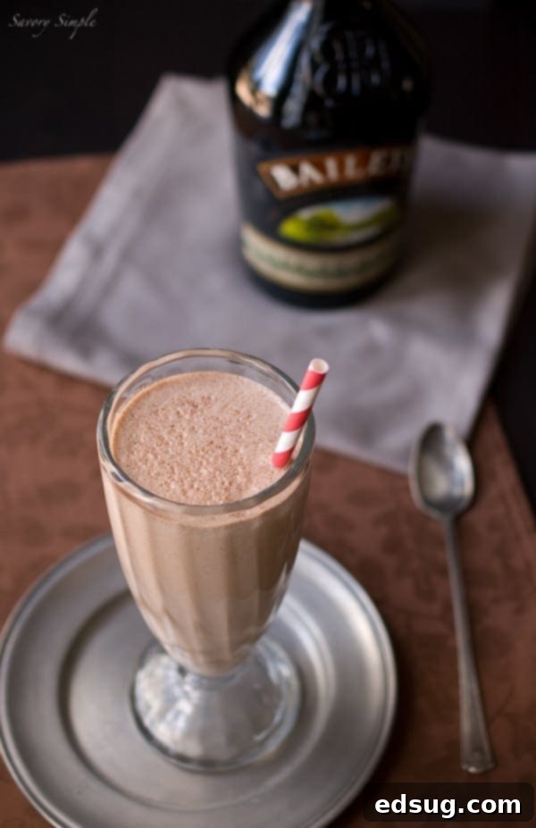 Decadent Nutella Irish Cream Milkshake Rich Nutella Irish Cream Milkshake in a glass, garnished with whipped cream and chocolate shavings