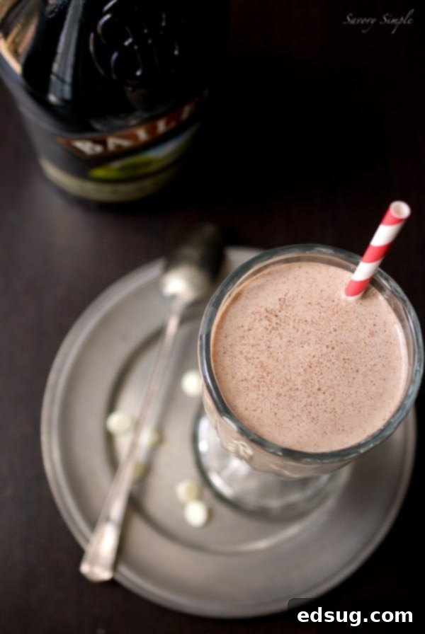 Nutella Irish Cream Milkshake Perfection Close-up of a frothy Nutella Irish Cream Milkshake with a straw, ready to be enjoyed