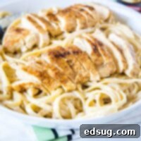 cajun chicken alfredo close up with sliced chicken on top