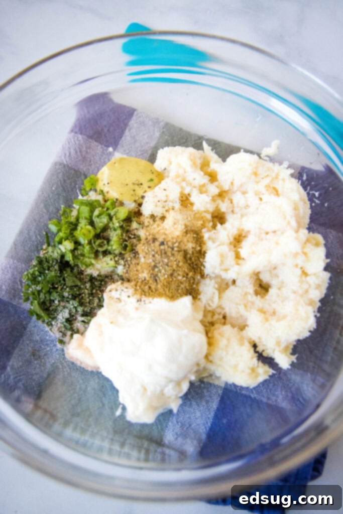 creamy crab puff filling in a mixing bowl with a spoon, ready to be added to pastry