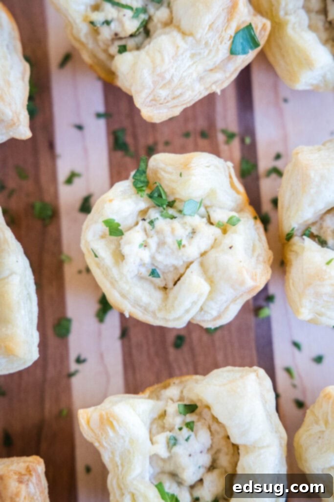 baked crab puffs sprinkled with fresh parsley, arranged on a wooden cutting board