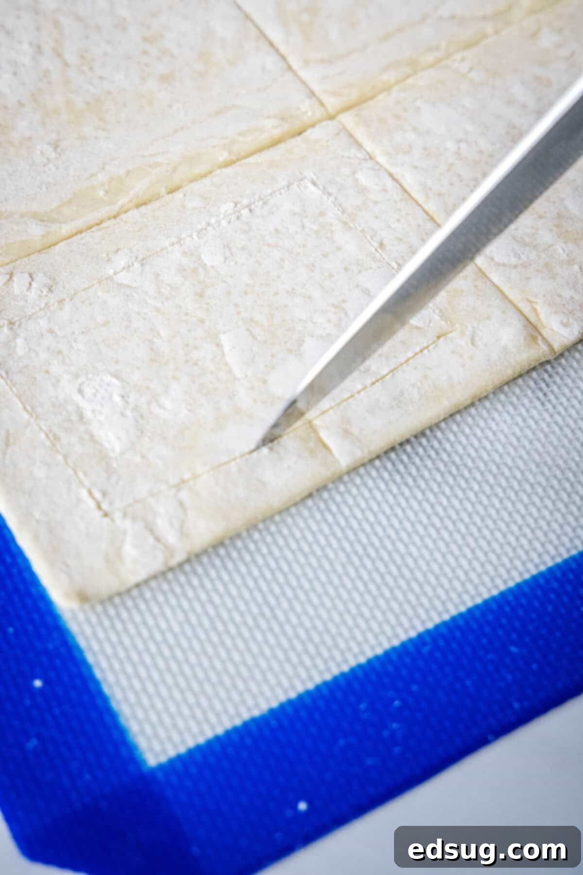 Decadent Cream Cheese Danish 3 Scoring a half-inch border into puff pastry dough rectangles with a knife