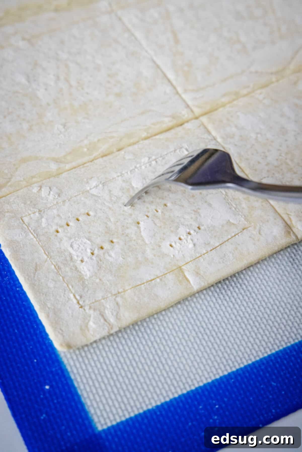 Decadent Cream Cheese Danish 4 Piercing the center of a puff pastry rectangle with a fork to prevent over-rising