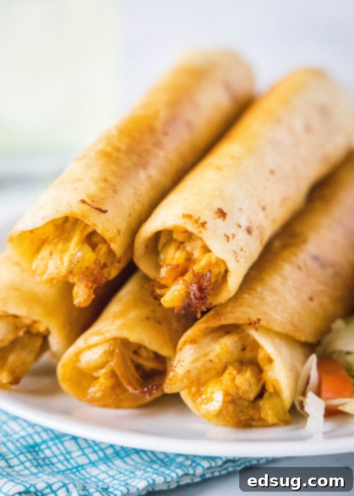 flautas stacked on a white plate