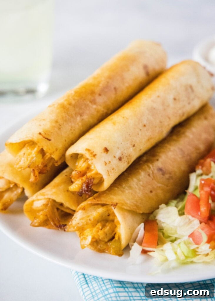 stack of flautas on a white plate