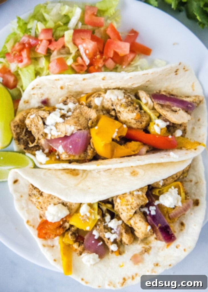 Platter of cooked Instant Pot Chicken Fajitas with tortillas and toppings.