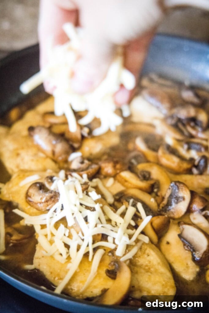 Chicken Lombardy 4 sprinkling cheese over chicken and mushrooms in a skillet