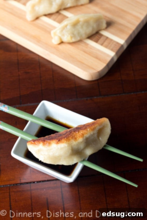 Pan Fried Shrimp and Pork Potstickers pan fried shrimp and pork potstickers on a board