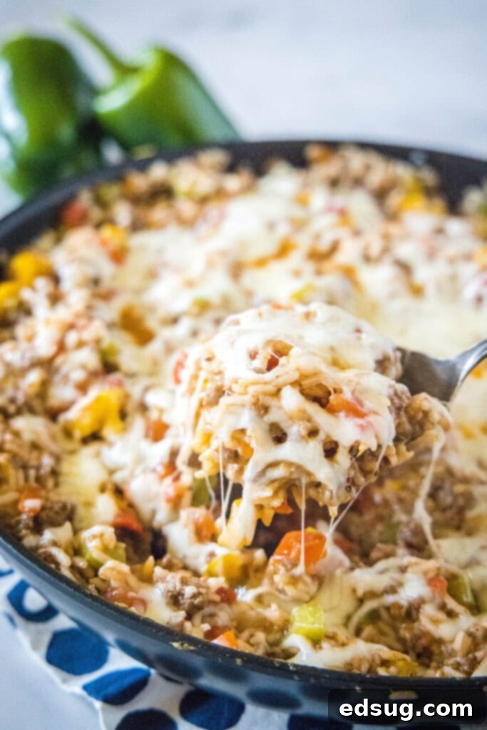 Hearty Stuffed Pepper Casserole 2 spooning out casserole from a skillet