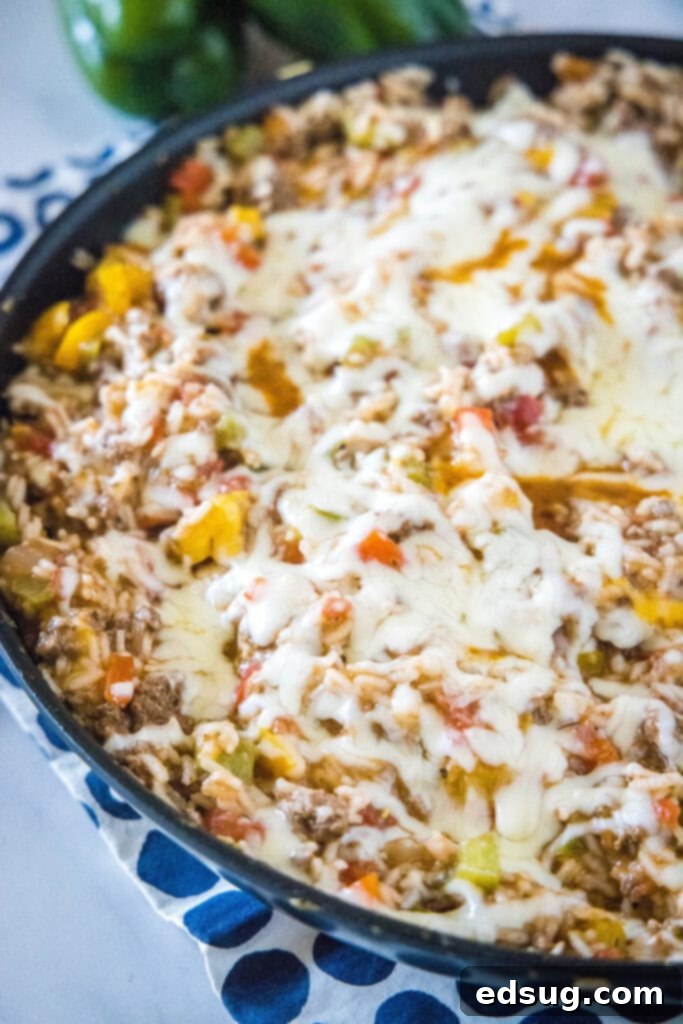 Hearty Stuffed Pepper Casserole 6 a skillet with melted cheese over ground beef in it