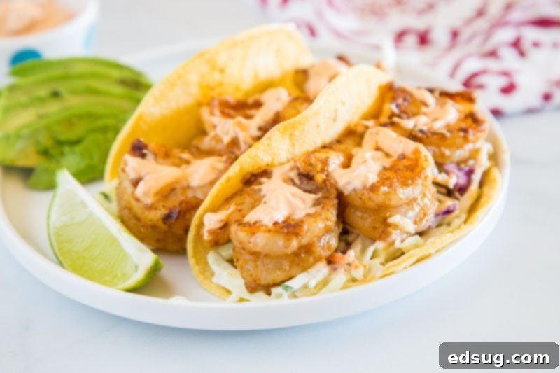 Chipotle Shrimp Tacos - An easy shrimp taco recipe with spiced shrimp, a cool lime coleslaw, and topped with creamy chipotle sauce.  Packed with so much flavor and ready in minutes, so it is perfect for a weeknight dinner.
