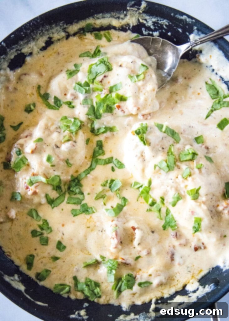 skillet with marry me chicken topped with basil