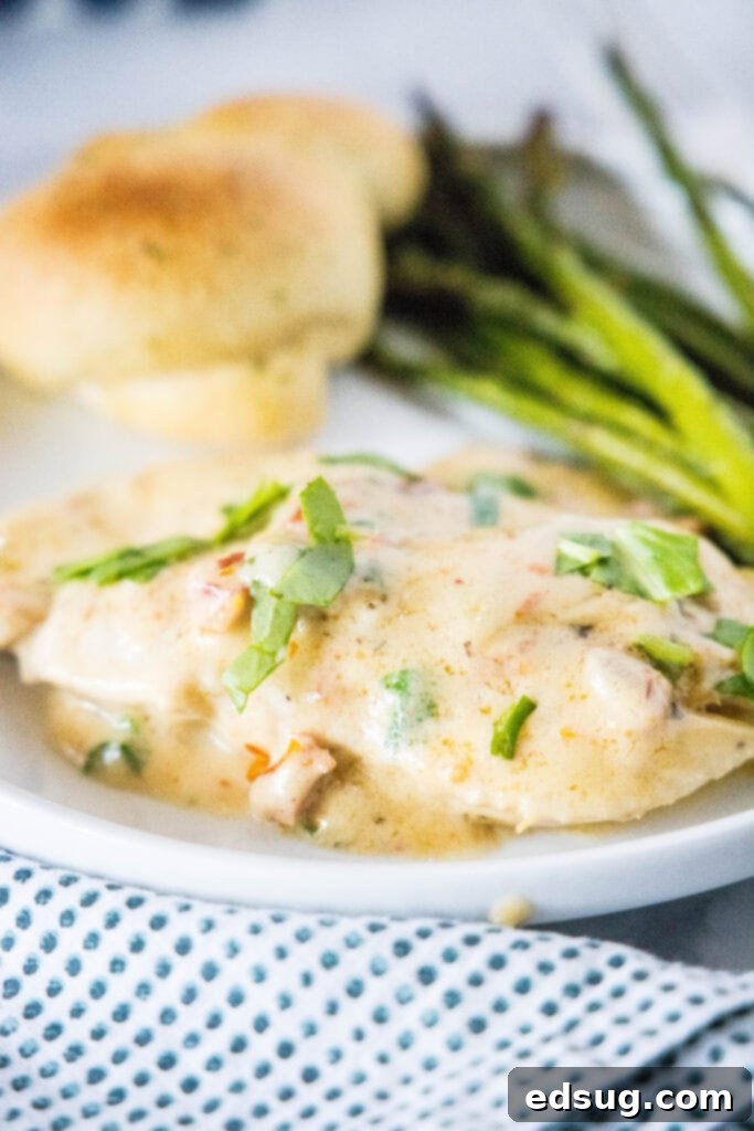 marry me chicken on plate with asparagus and bread