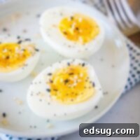 close up hard boiled eggs on a white plate