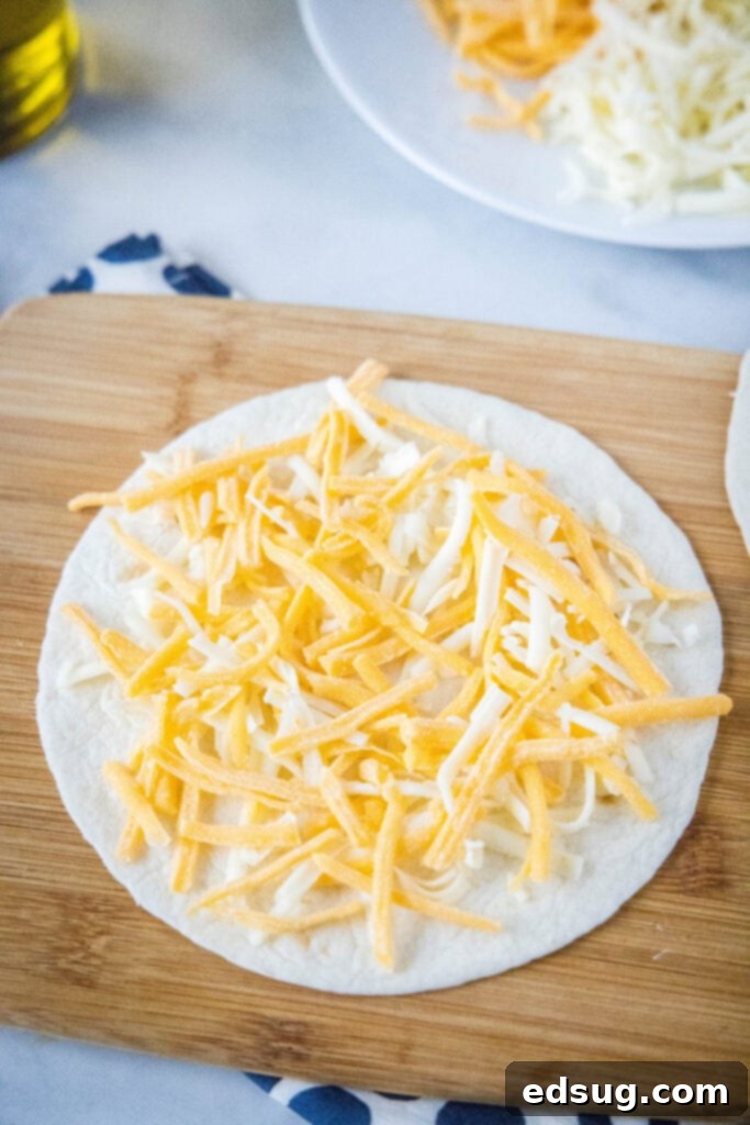 Melty Cheese Quesadilla 4 Shredded cheese generously spread over a flour tortilla, ready for assembly.