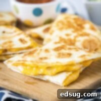 cropped close up of a sliced quesadilla on a cutting board
