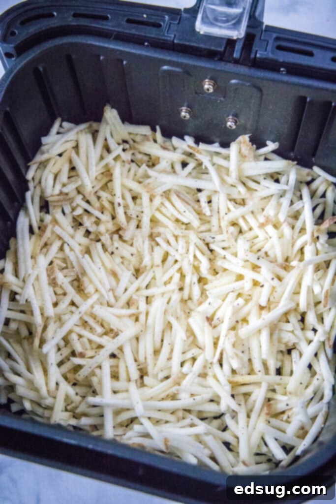shredded potatoes in air fryer basket