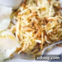 close up crispy air fryer hash browns on plate
