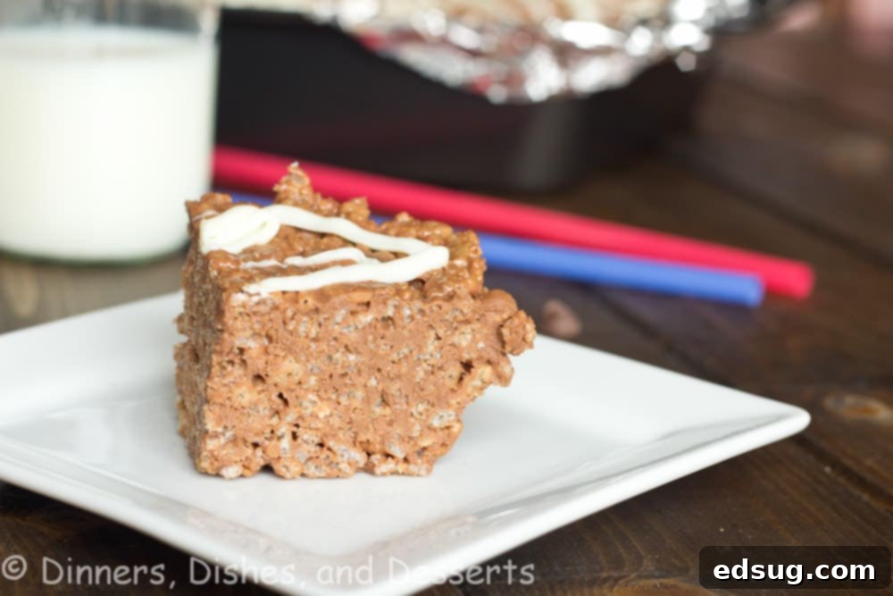 Chocolate Peanut Butter Krispie Treat Several Chocolate Peanut Butter Rice Krispie Treats arranged neatly on a white plate, ready to be enjoyed.