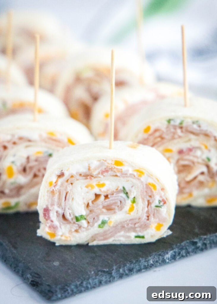 pinwheel sandwich arranged on a board with toothpicks