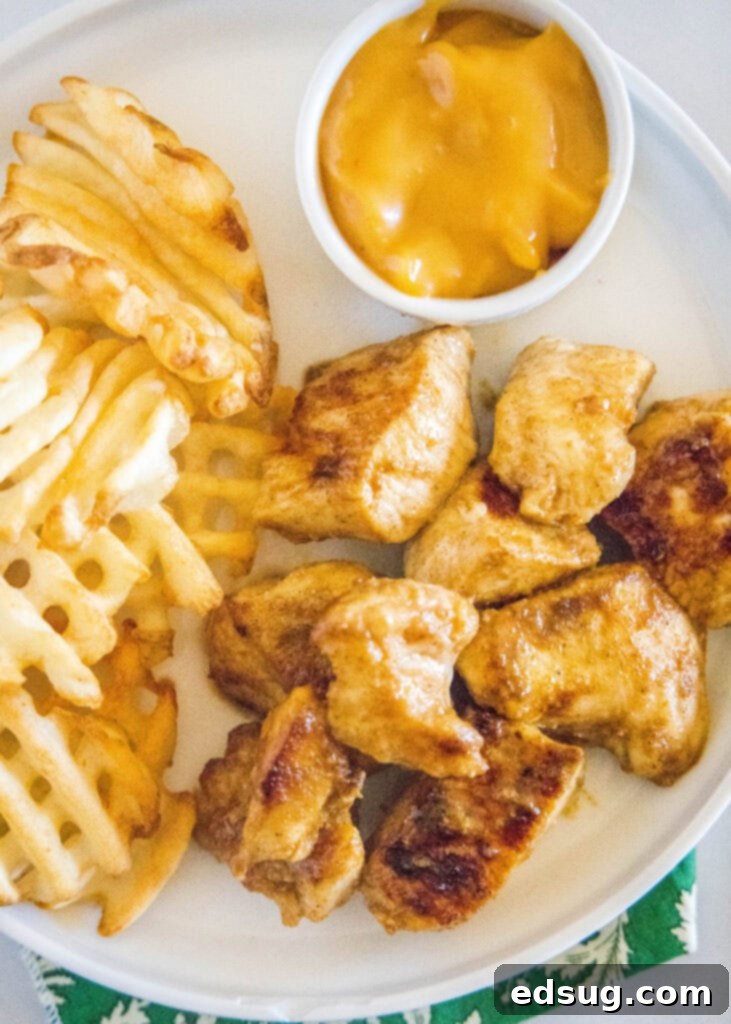 Signature Grilled Chicken Bites 7 Overhead view of Chick-Fil-A inspired grilled nuggets served with classic waffle fries
