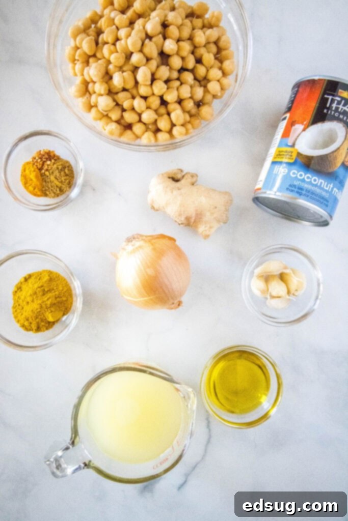 Golden Chickpea Delight 3 Collection of fresh ingredients for making chickpea curry, including chickpeas, spices, coconut milk, and aromatics