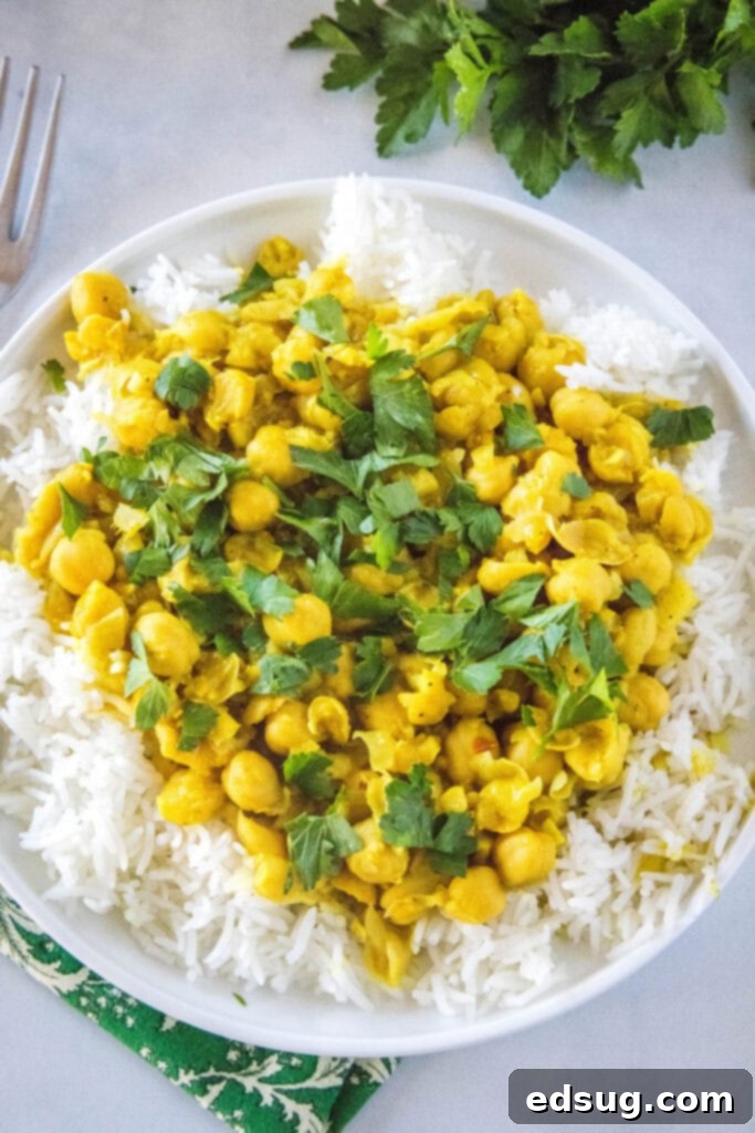 Golden Chickpea Delight 4 Overhead view of a white plate filled with savory chickpea curry and white rice