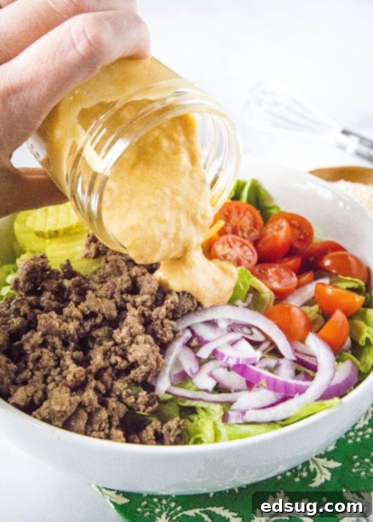 Big Mac Style Salad 5 Pouring the creamy homemade special sauce over a fresh Big Mac Salad.