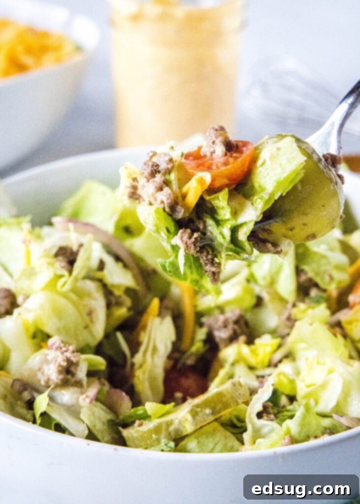Big Mac Style Salad 7 A fork lifting a perfect bite of Big Mac Salad, showing the layers of ingredients.