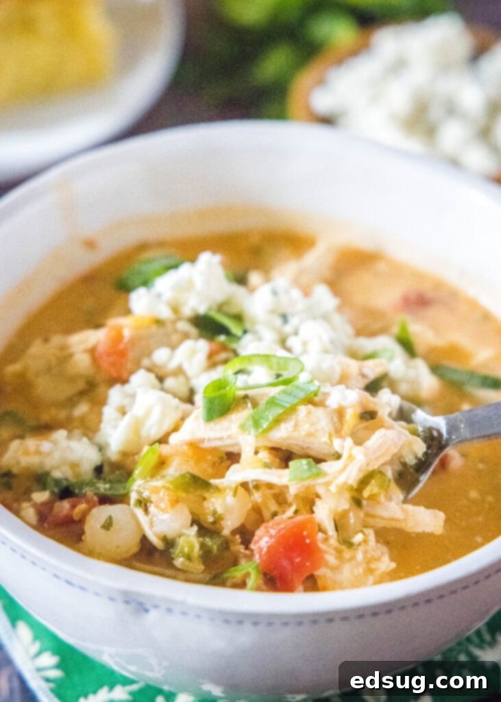 Buffalo Chicken Chili 5 spooning a bite of chicken chili out of a bowl