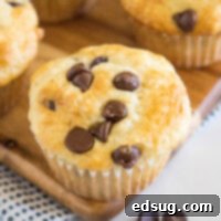 Close up of a chocolate chip buttermilk muffin on a wooden platter.