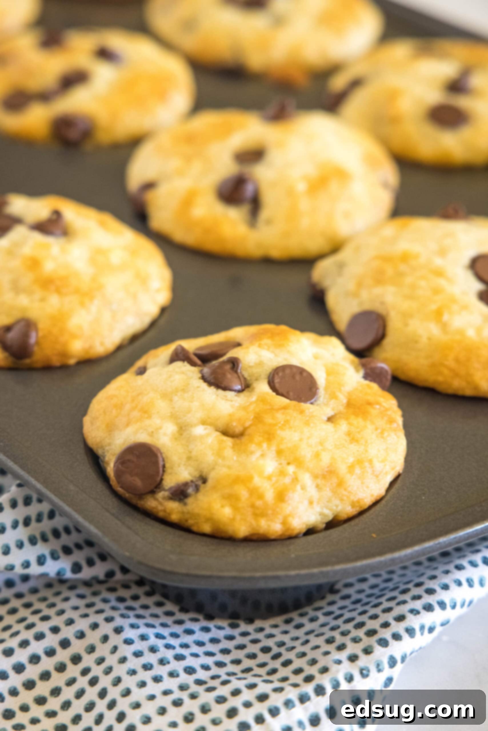 Freshly baked buttermilk muffins cooling in a muffin pan.