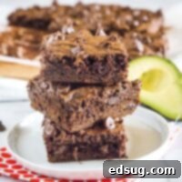 Decadent Avocado Brownies 6 close up avocado brownies stacked on a white plate